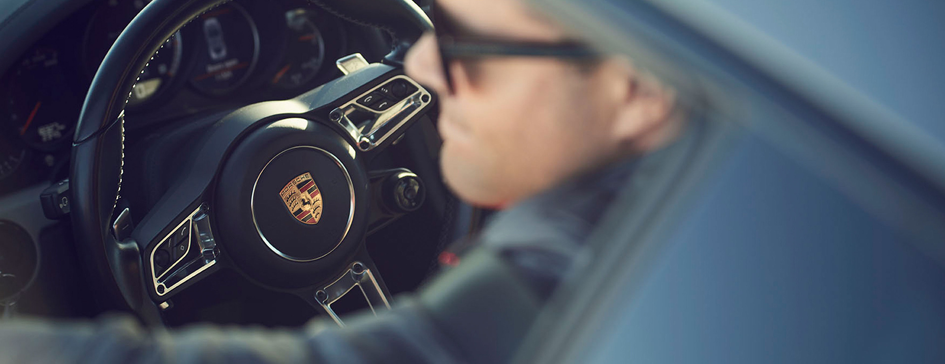 Person im Porsche Fahrzeug.